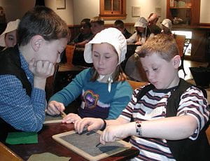 Students in the Michigan Historical Museum's BIG History Lesson learn in the museum's one-room school. Students in museum's one-room school