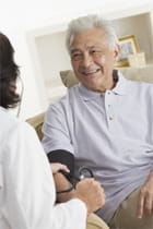 doctor taking man's blood pressure