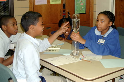 Students study some of the properties of air by using a vortex (tornado)
tube.