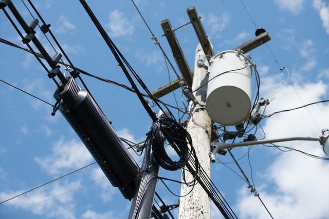 Telephone pole and electrical lines with a transformer