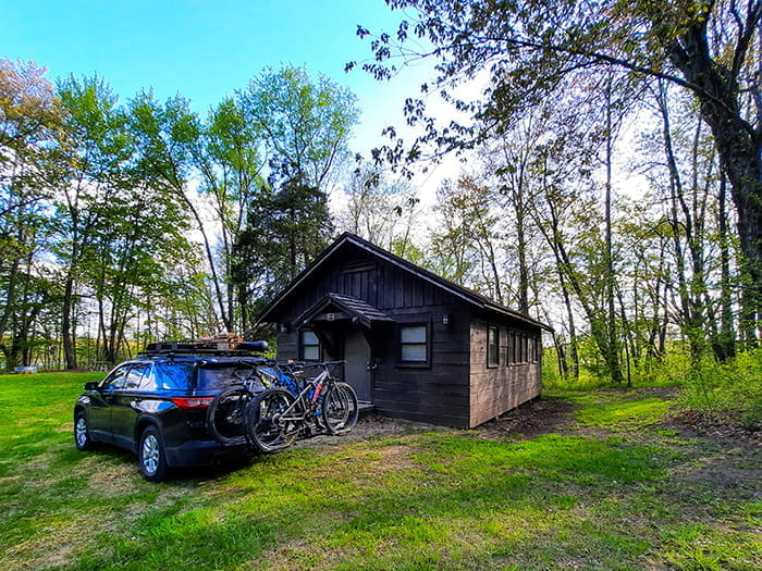 Car parked in front of Mill cabin by Kevin Roberts