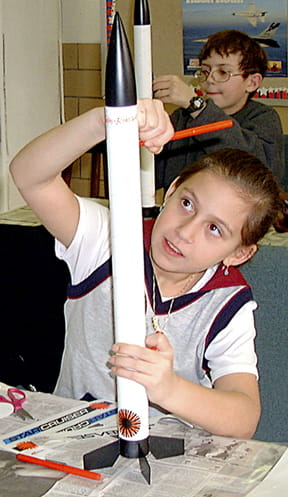 A STARBASE student decorates Starcruiser rocket she built.