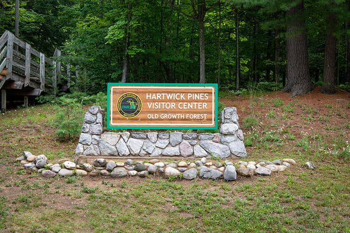 The sign for the Hartwick Pines Visitor Center