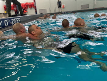 people practicing water rescues