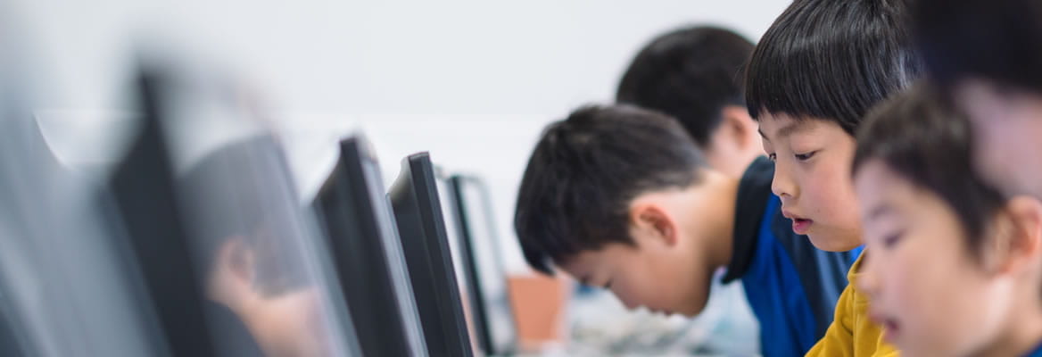 young children sitting at computers