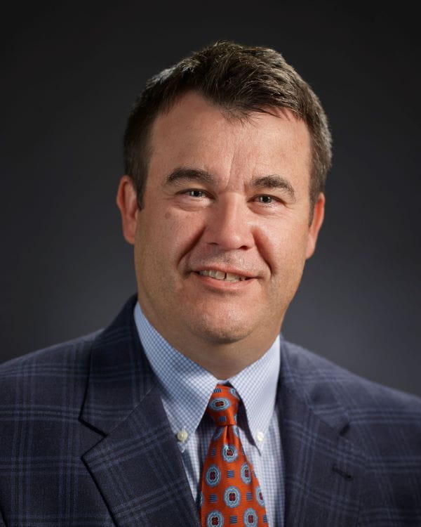 Man in front of blue background