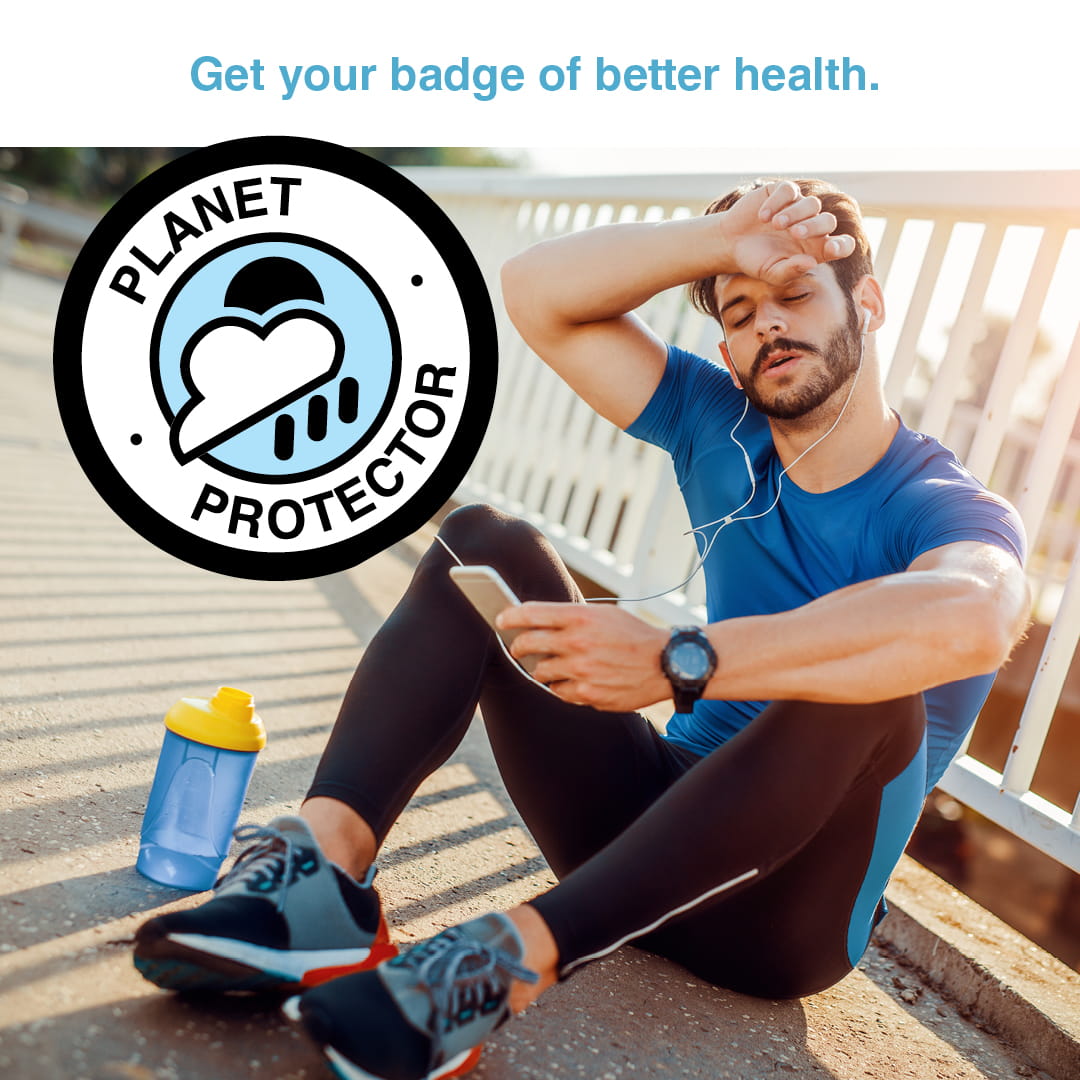 man sitting in sun with back of hand on forehead, and badge reading "planet protector"