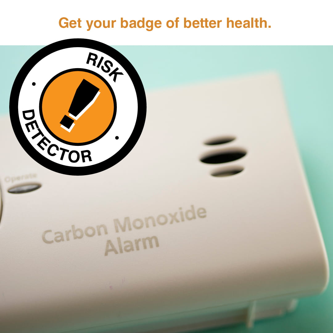 Carbon monoxide detector and badge reading "risk detector"