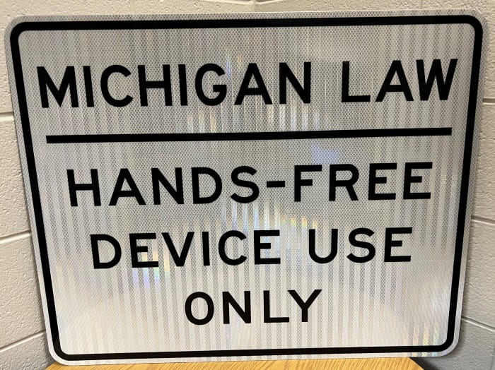 Michigan Law Hands-free Device Use Only sign.