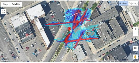 An overhead image of a Detroit-area intersection with color-coded dots and lines created from video data capturing pedestrian movements.