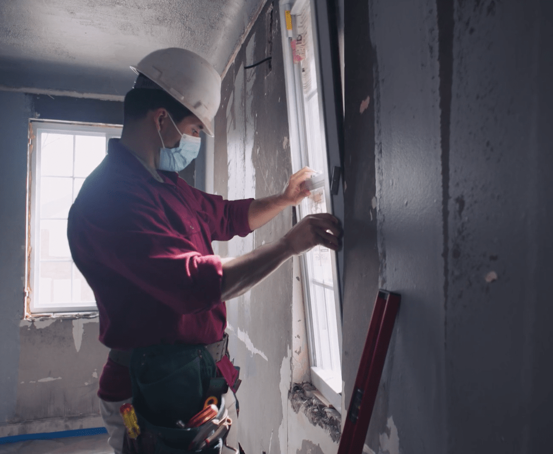 Lead abatement worker installing a new window