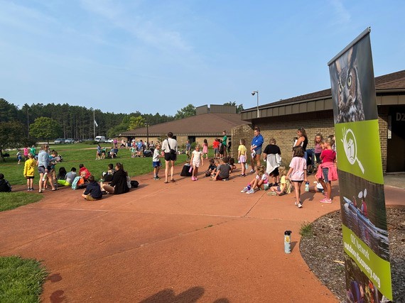 Children gathered outdoors at an Outdoor Discovery Center event