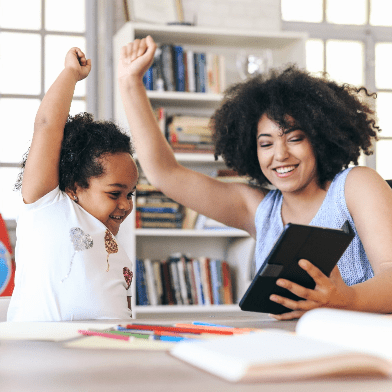 Photograph of a woman and a young child cheering