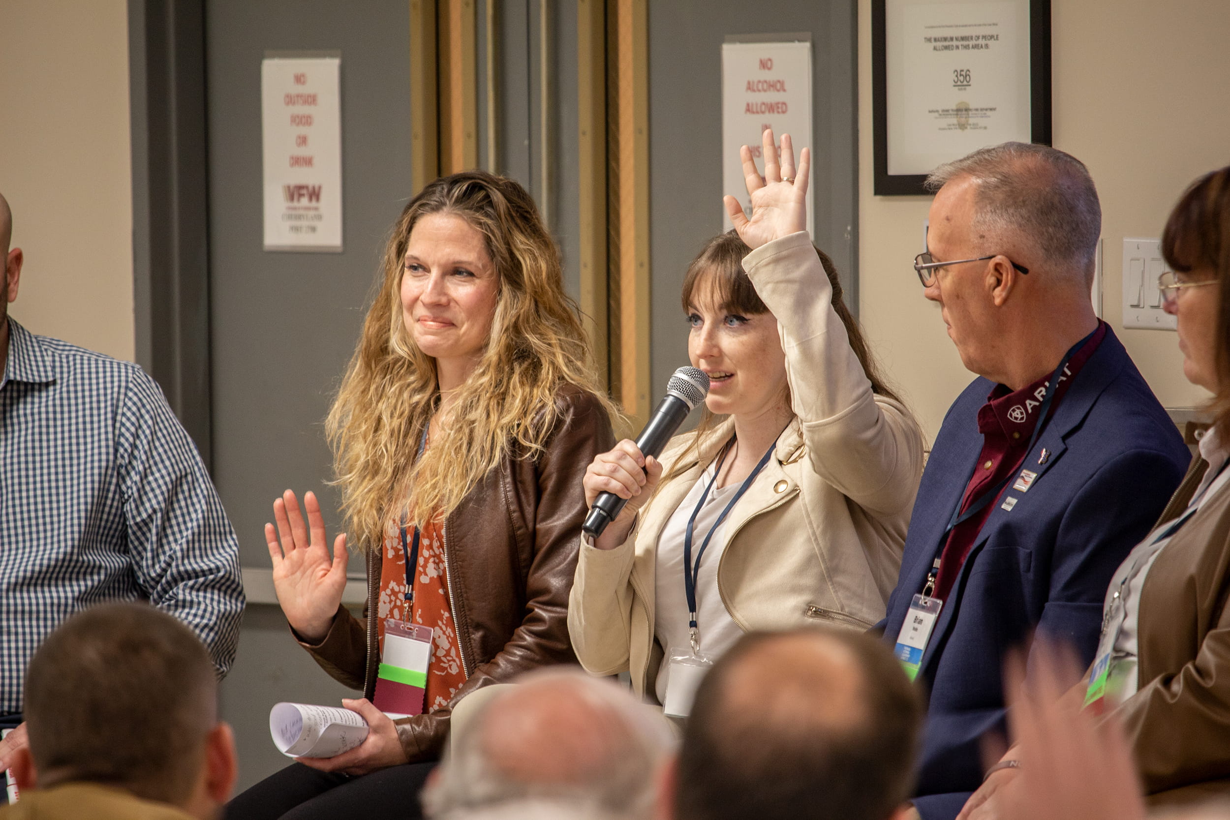 Women asking questions at Michigan Veterans Leadership Summit panel