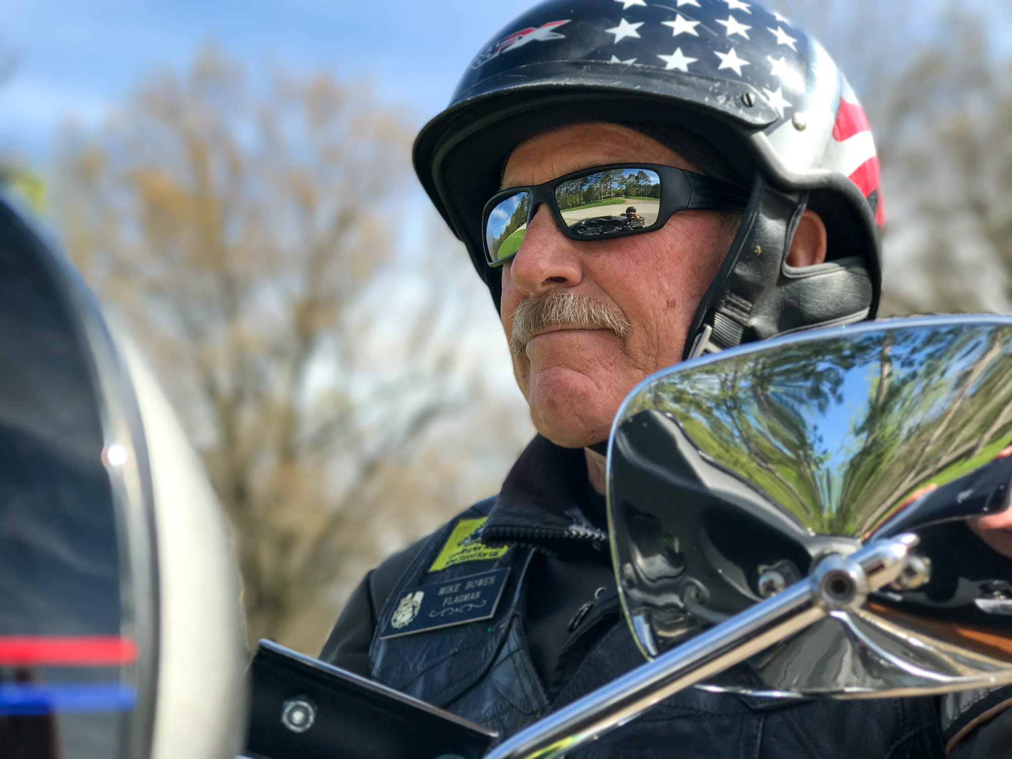 light skinned man wearing American flag decorated motorcycle helmet