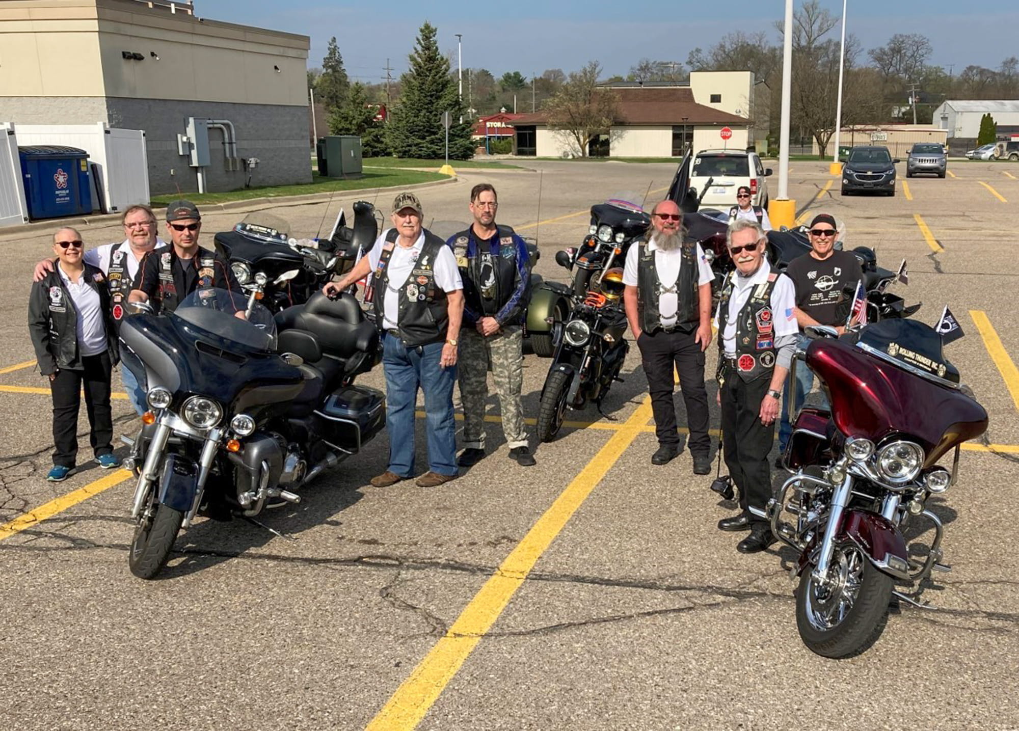 light-skinned men in black leather standing next to motorcyles