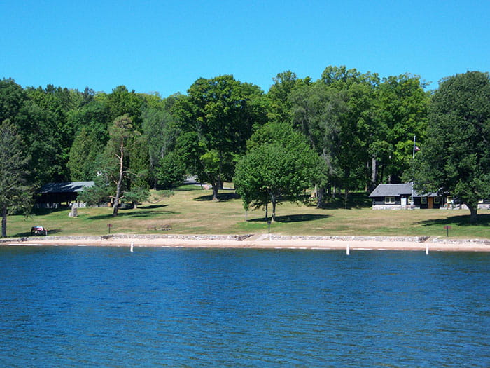 shoreline with trees and structure in background